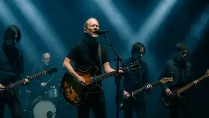 Radiohead performing live on stage with Thom Yorke singing and playing guitar under dramatic stage lights.